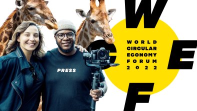 Two journalists and two giraffes and the WCEF2022 logo